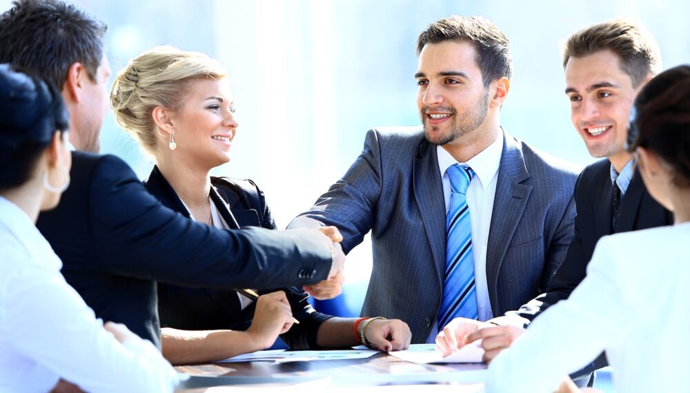 Two business colleagues shaking hands during meeting